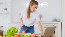 Seorang remaja perempuan sedang tersenyum sambil memegang semangkuk salad buah segar yang penuh warna, menunjukkan pilihan camilan sehat yang mendukung gaya hidup aktif dan penuh semangat. Gambar ini merepresentasikan pentingnya nutrisi seimbang bagi pertumbuhan remaja yang optimal.