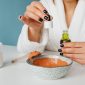 Semangkuk bahan-bahan segar seperti alpukat, madu, dan oatmeal yang siap diolah menjadi masker wajah alami di rumah. Tampilan ini menggambarkan kesederhanaan dan potensi kekayaan alam untuk perawatan kulit optimal.